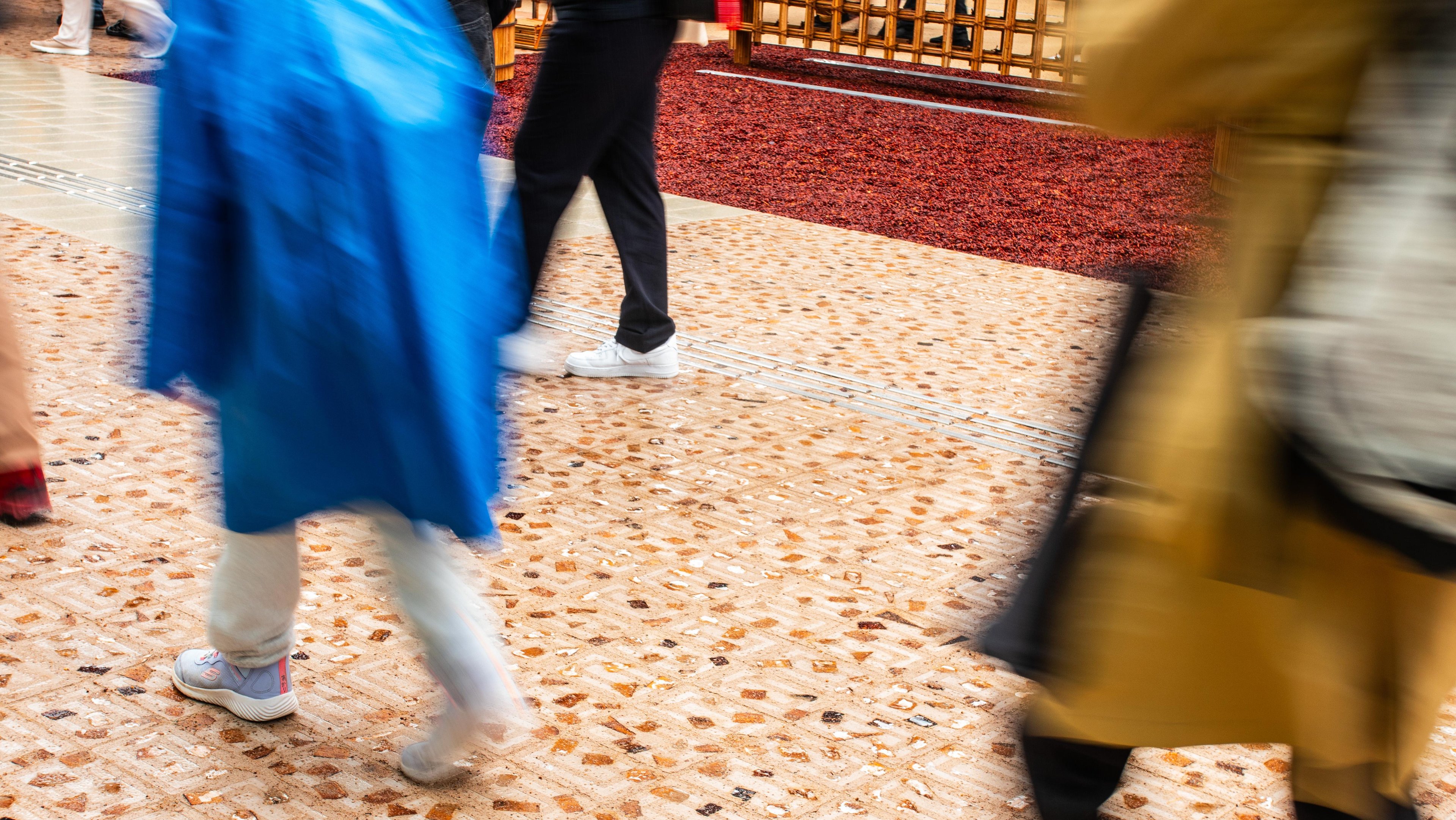 Close up motion blur shot showing more people walking on the Datecrete pavers.