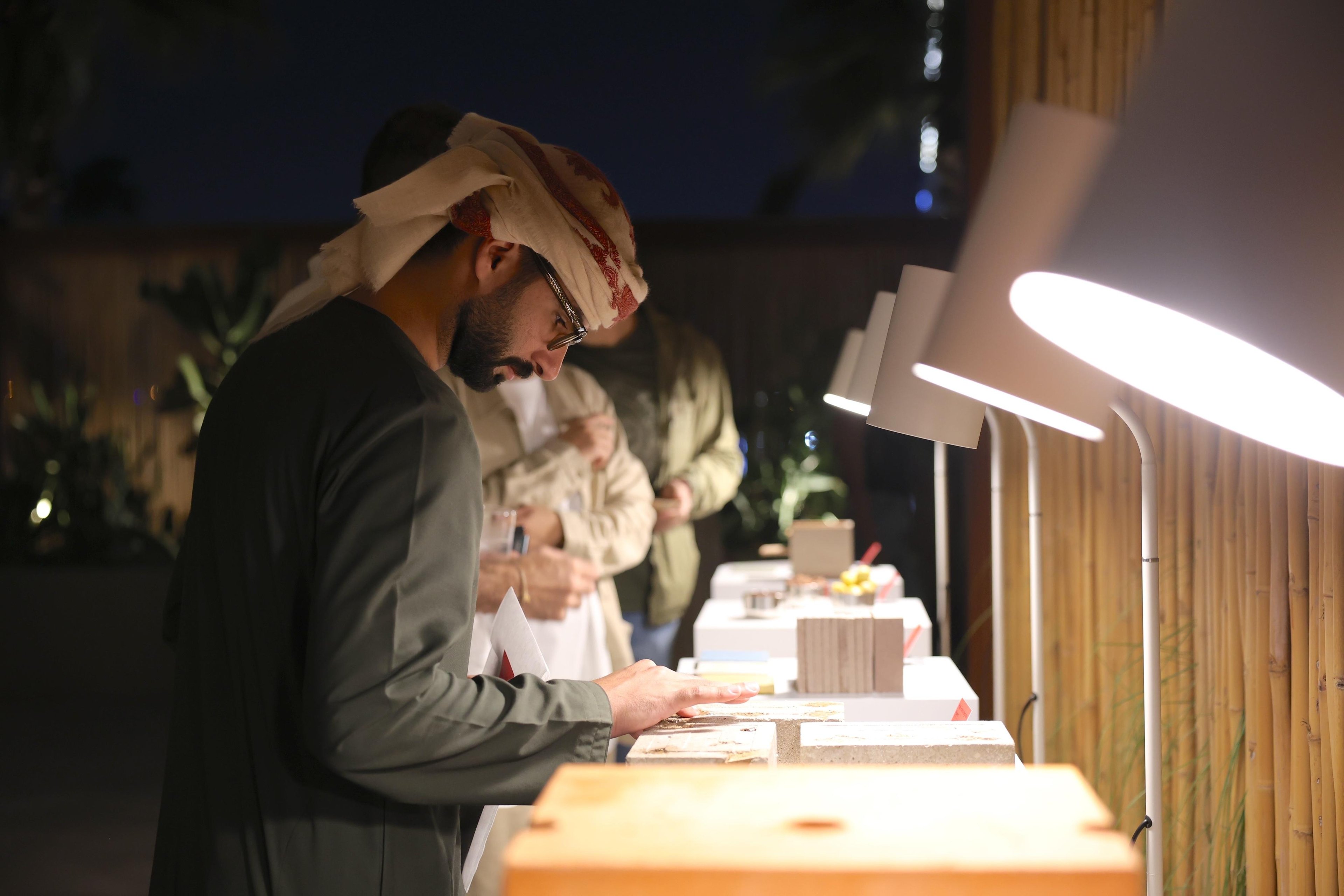 Attendees of the showcase event touching the grazing scape.