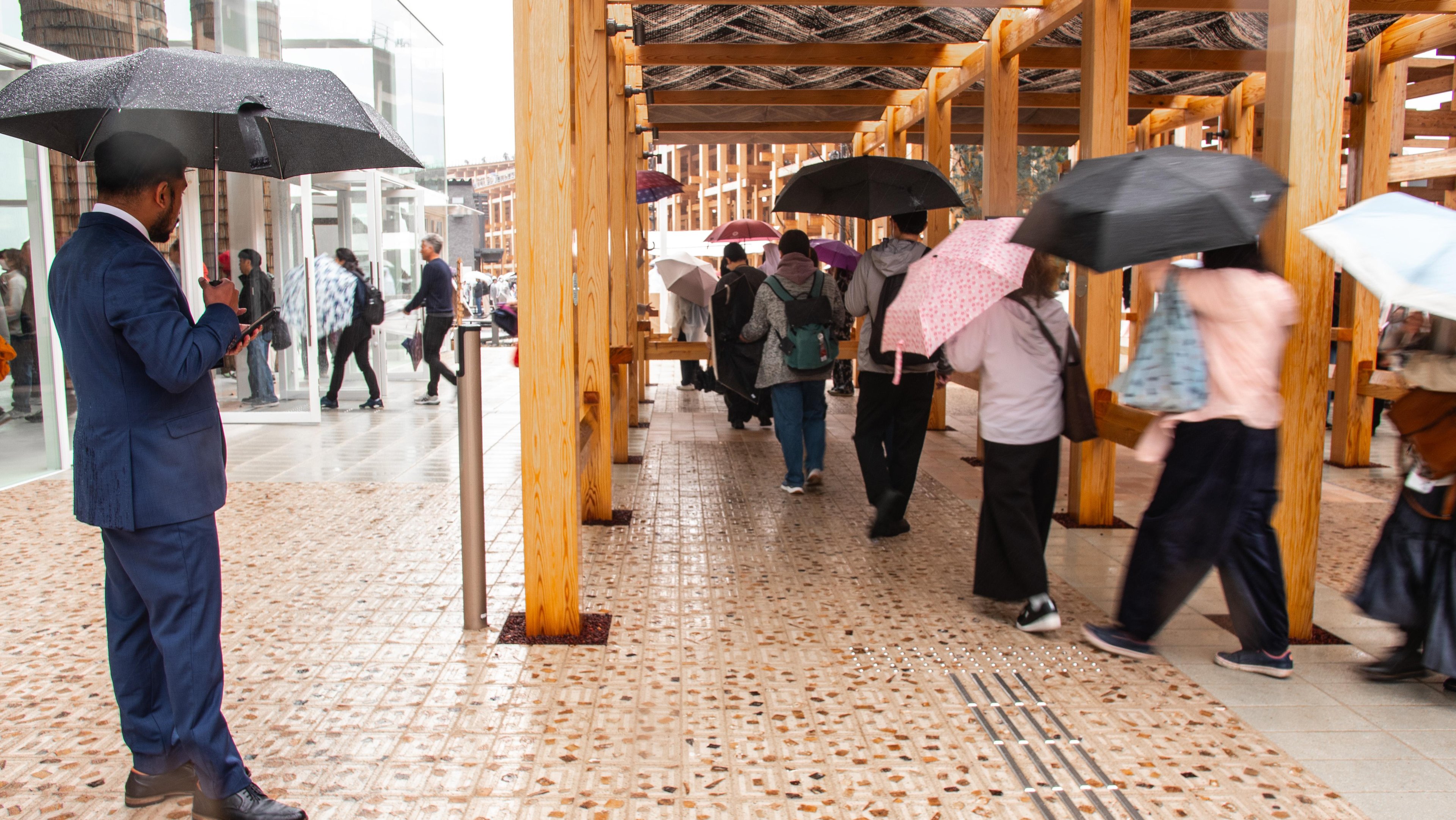 Shot of people standing atop a section of palm-frond-imbued Datecrete pavers.