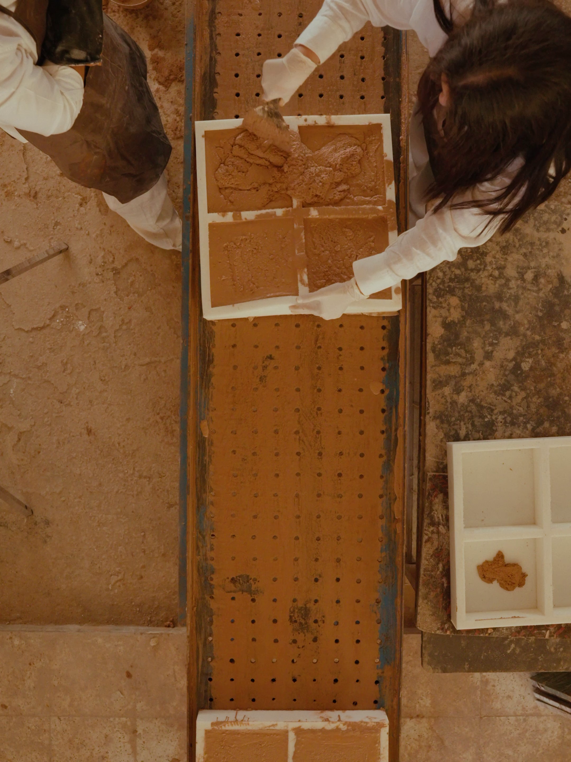 Sara and Khaled casting the Datecrete mix into molds.