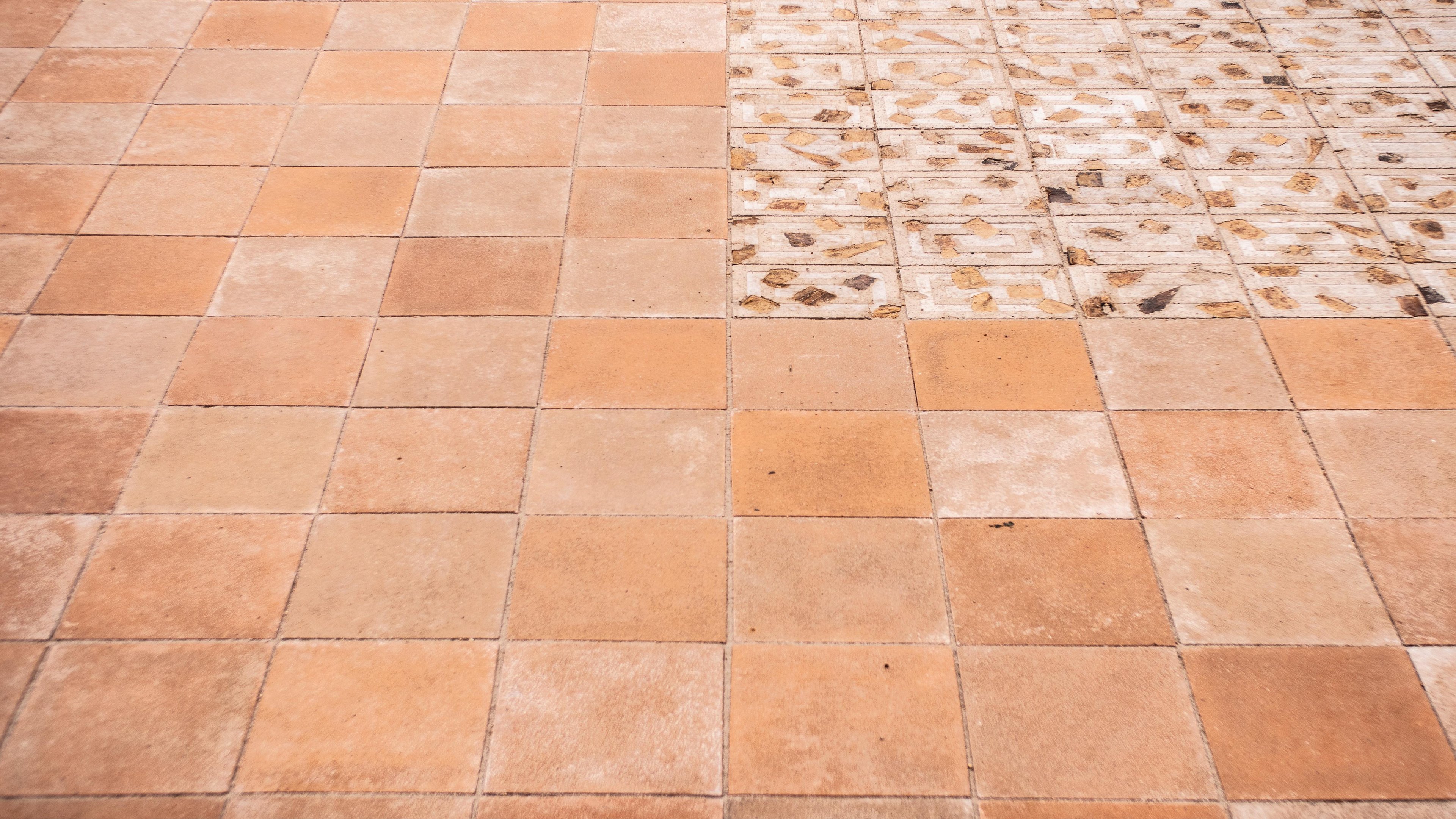 Close up shot highlighting the Sienna-tinted as well as palm-frond-imbued variants of the Datecrete pavers.