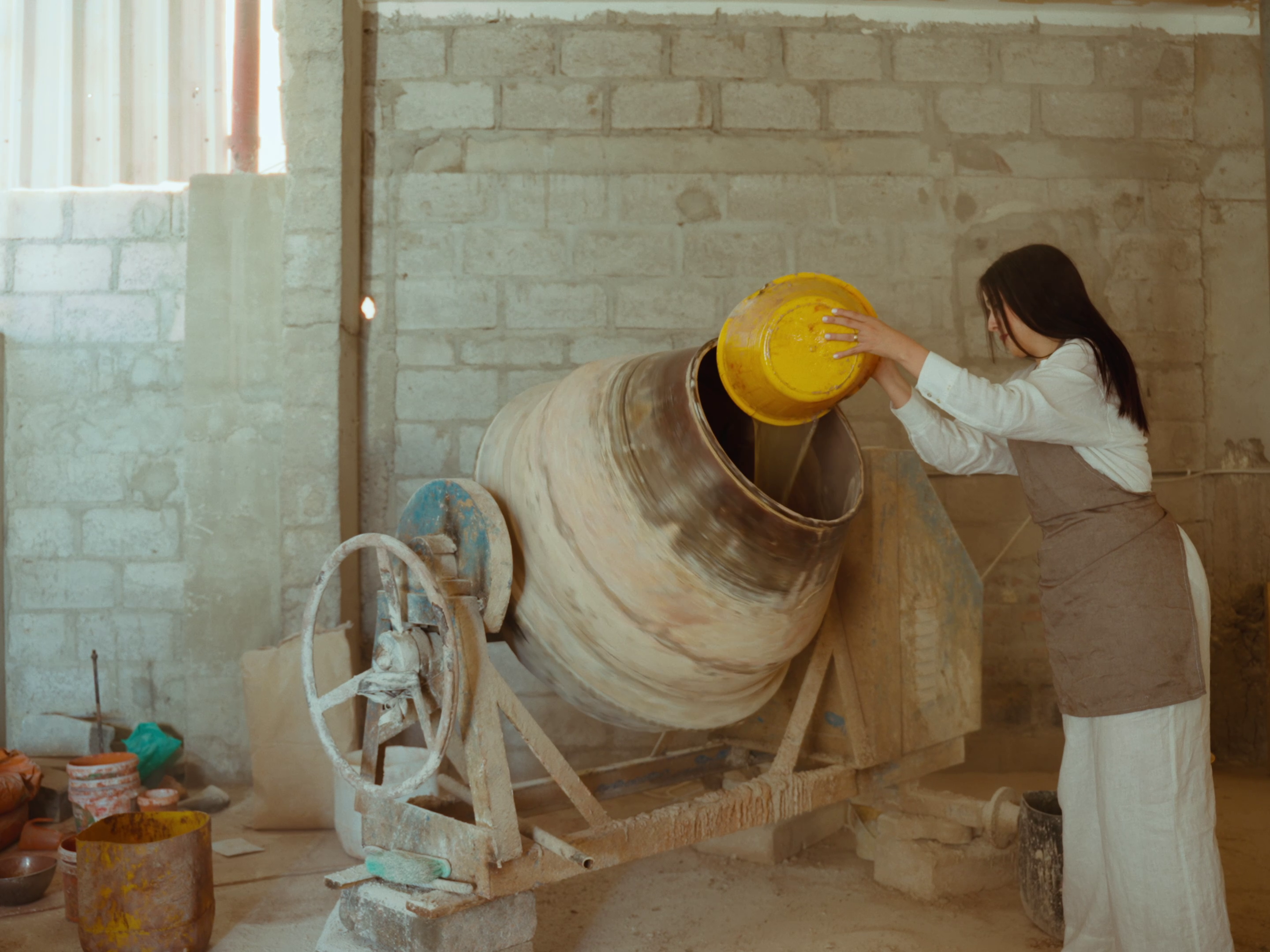Sara pouring the ingredients into a mixer.
