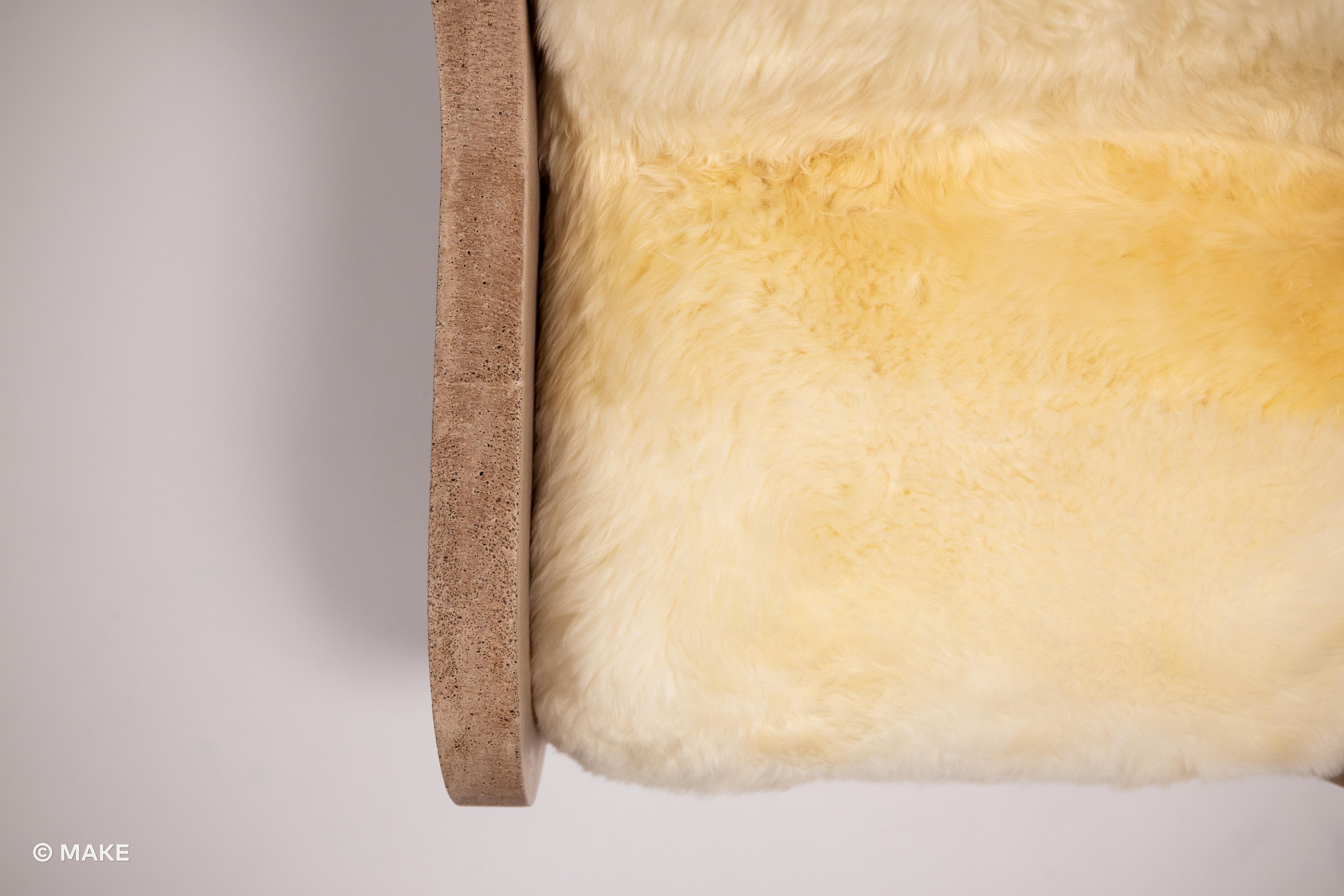 Overhead shot of the sheep upholstery on the seat of the Datecrete Accent Chair.