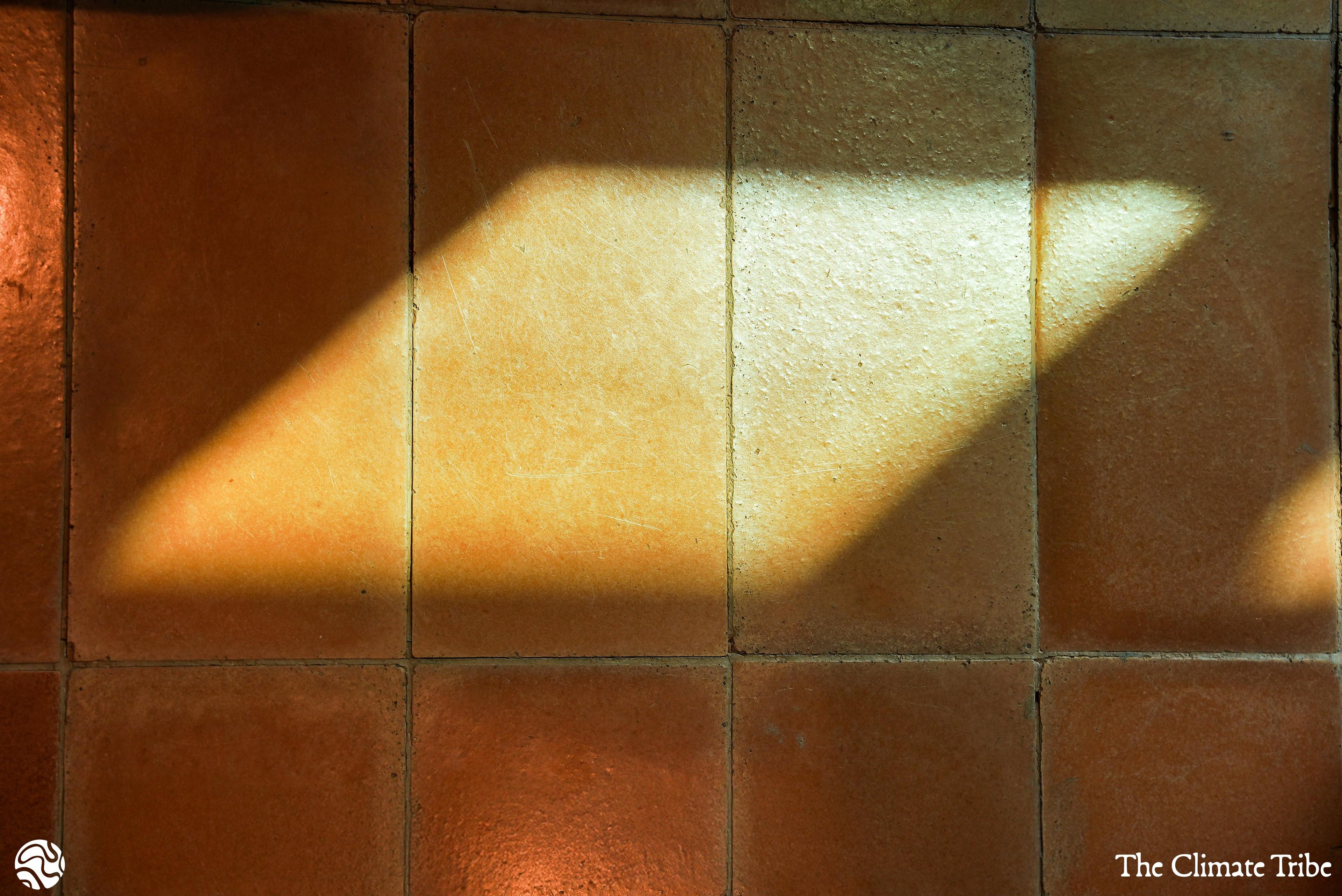 Close up shot of the Datecrete Sienna tiles, with sunlight casting a parallelogram-like light-spot on them.
