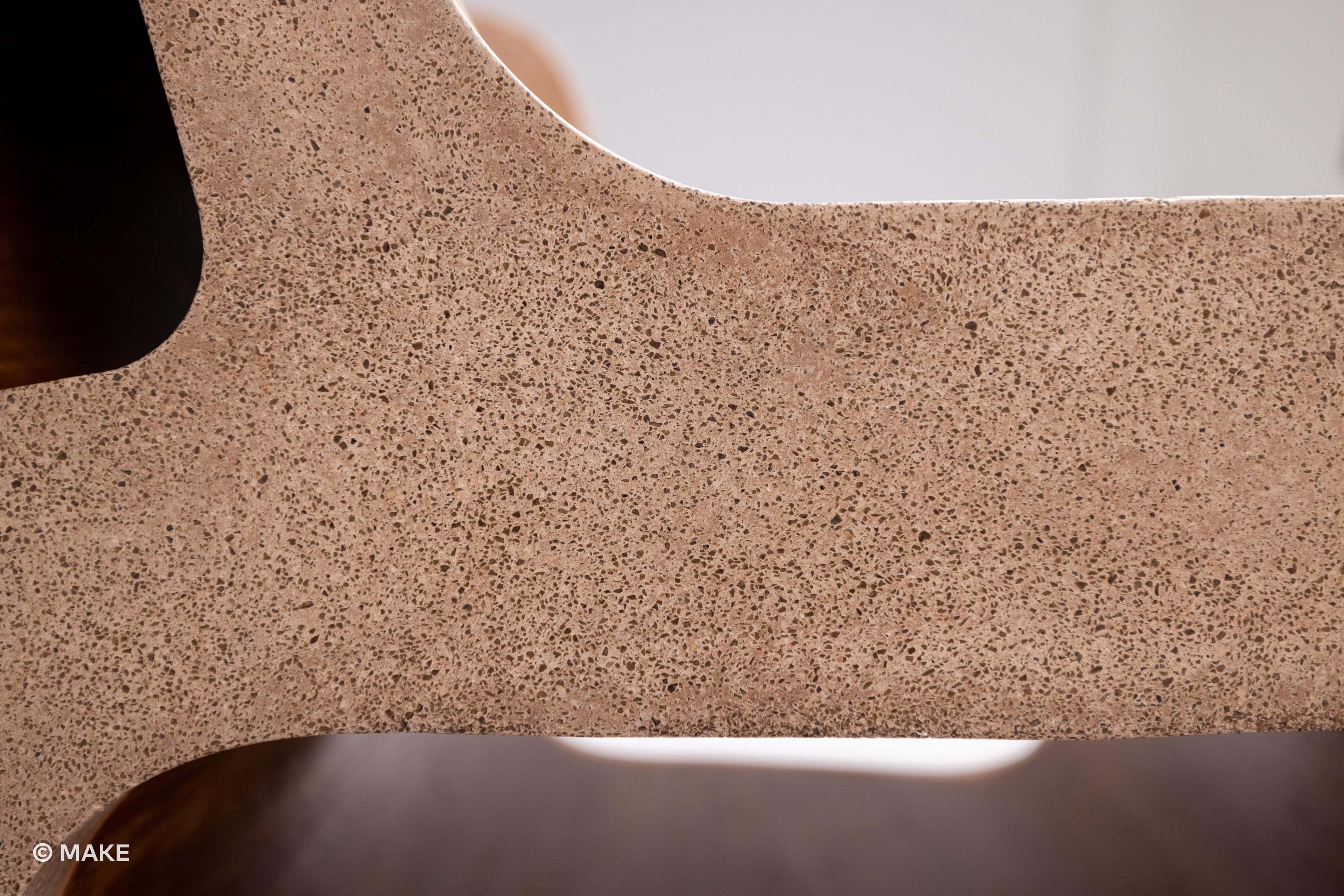 Close-up of the arm of the Datecrete Accent Chair.